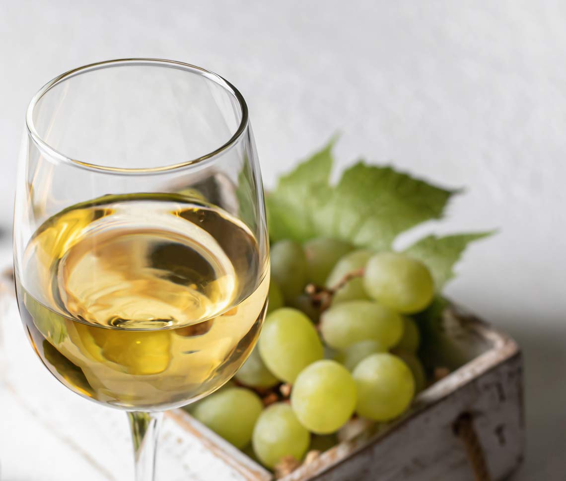 white wine with grapes wooden box